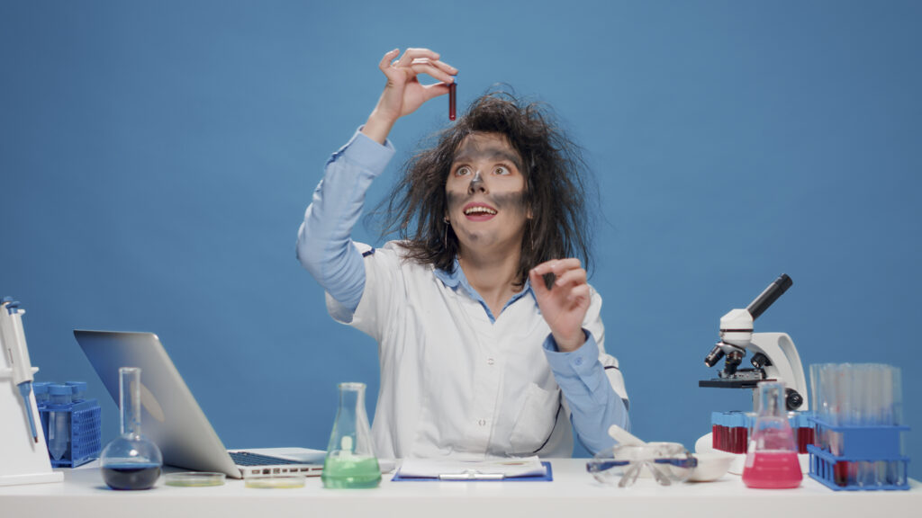insane-foolish-female-chemist-working-with-microscope-in-studio-scaled