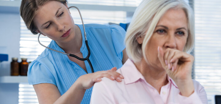 doctor-examining-coughing-patient-scaled