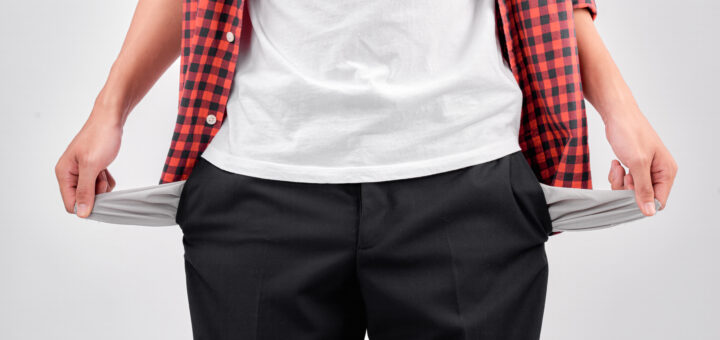 man-showing-his-empty-pockets-on-white-background-scaled
