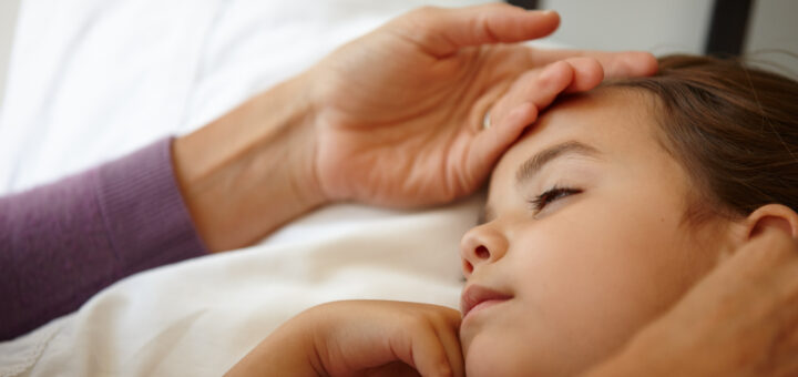 love-is-sitting-up-all-night-with-a-sick-child-a-caring-mother-feeling-the-forehead-of-her-sick-little-girl-scaled