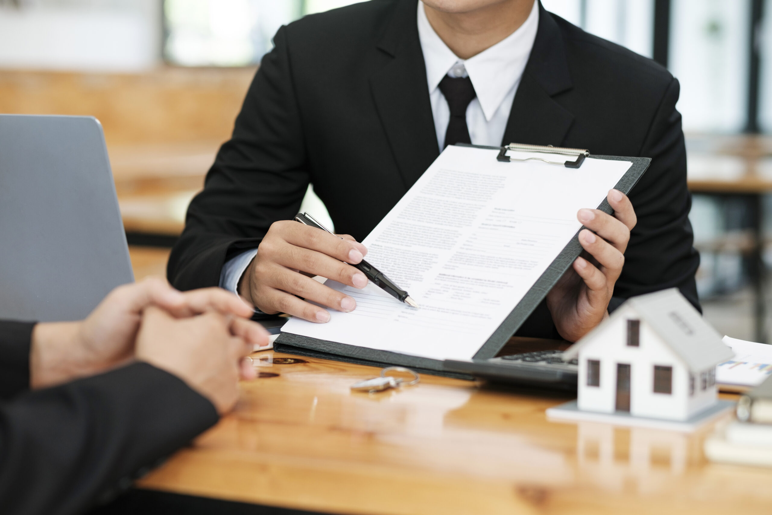 close-up-business-teamwork-signing-contract-partnership-agreement-making-deal-scaled