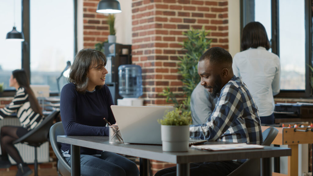 male-employee-greeting-female-candidate-at-job-interview-scaled