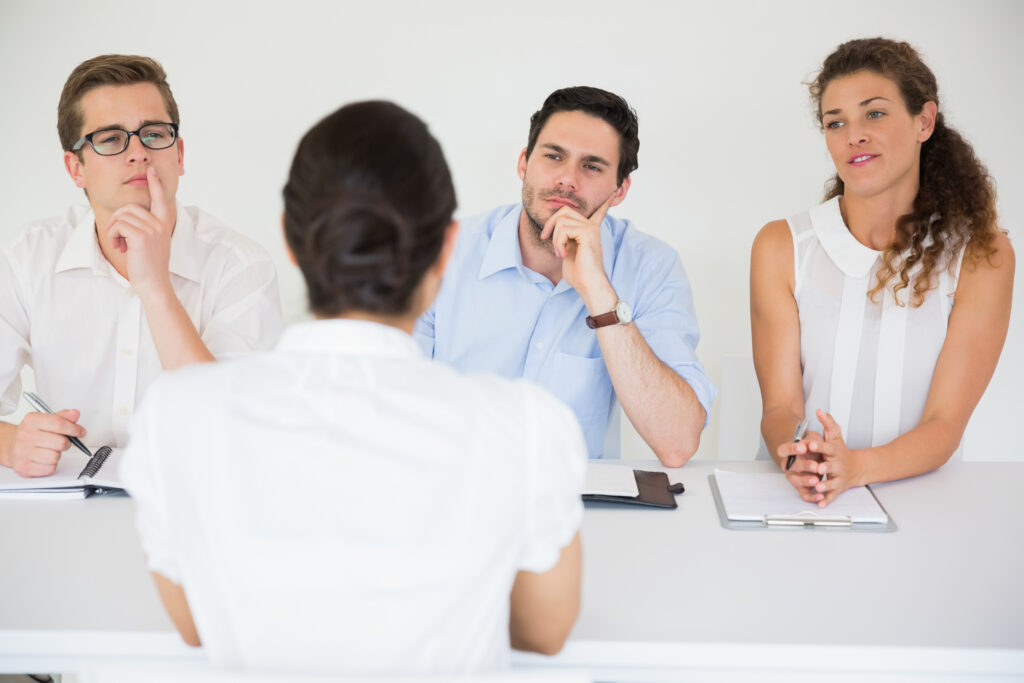 woman-being-interviewed-by-business-people-scaled