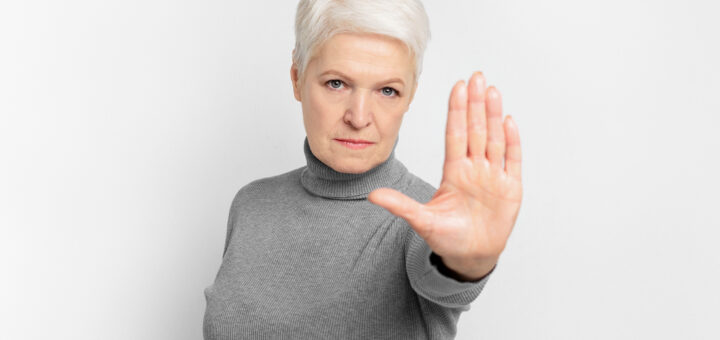 senior-lady-gesturing-stop-with-her-hand-scaled